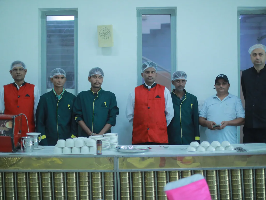 Catering team lined up behind a food service counter